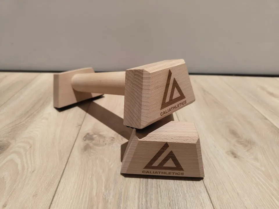 Caliathletics Wooden Parallettes Mini, the pair on a wooden floor